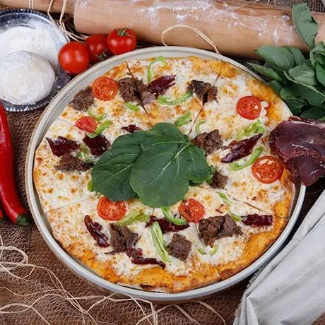 Leina Special Pizza - şefin özel pizza hamuru,  pizza sosu, mozeralla peyniri, dana jülyen et, dana sucuk, kavurma, renkli biberler, mantar, akdeniz yeşilliği parmesan peyniri ile servis edilir.
