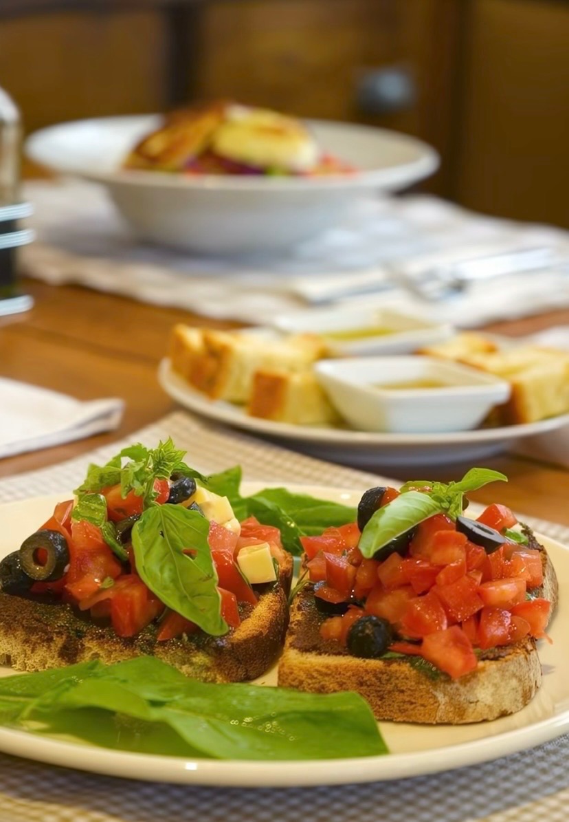 Bruschetta Pomodoro Mozzarella - Toasted sourdough with tomatoes, olives, mozzarella and garlic