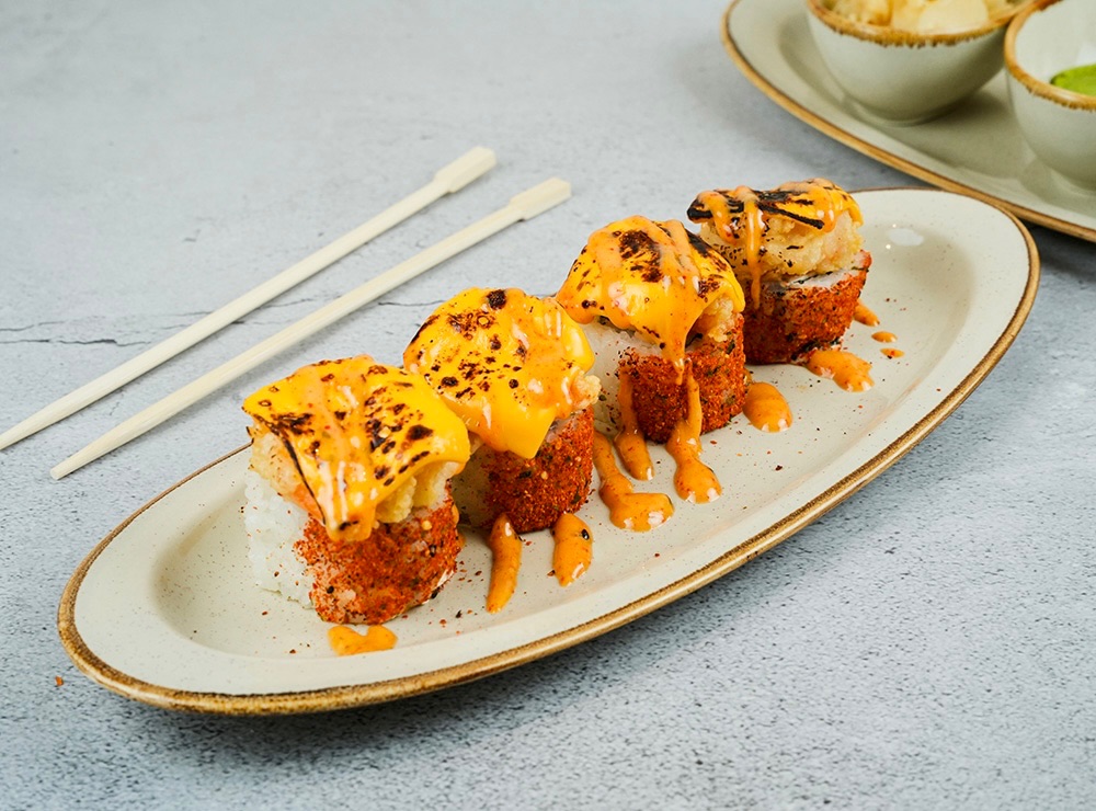 Fire Roll - 4pcs - Salmon, avocado, cheese philadelphia with fried shrimp on the top and covered by Cheddar cheese