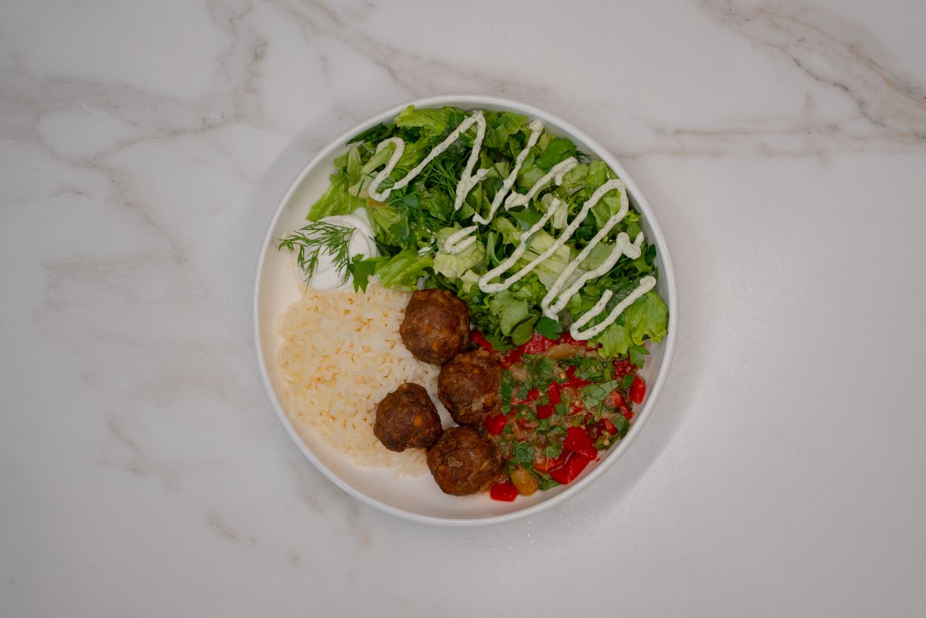 Köfte Bowl - El yapımı köfteler, tereyağlı pirinç pilavı, mevsim yeşillikleri ve renkli sebzelerle hazırlanan bu bowl; yoğurt ve özel sos eşliğinde lezzetli ve dengeli bir öğün sunar.