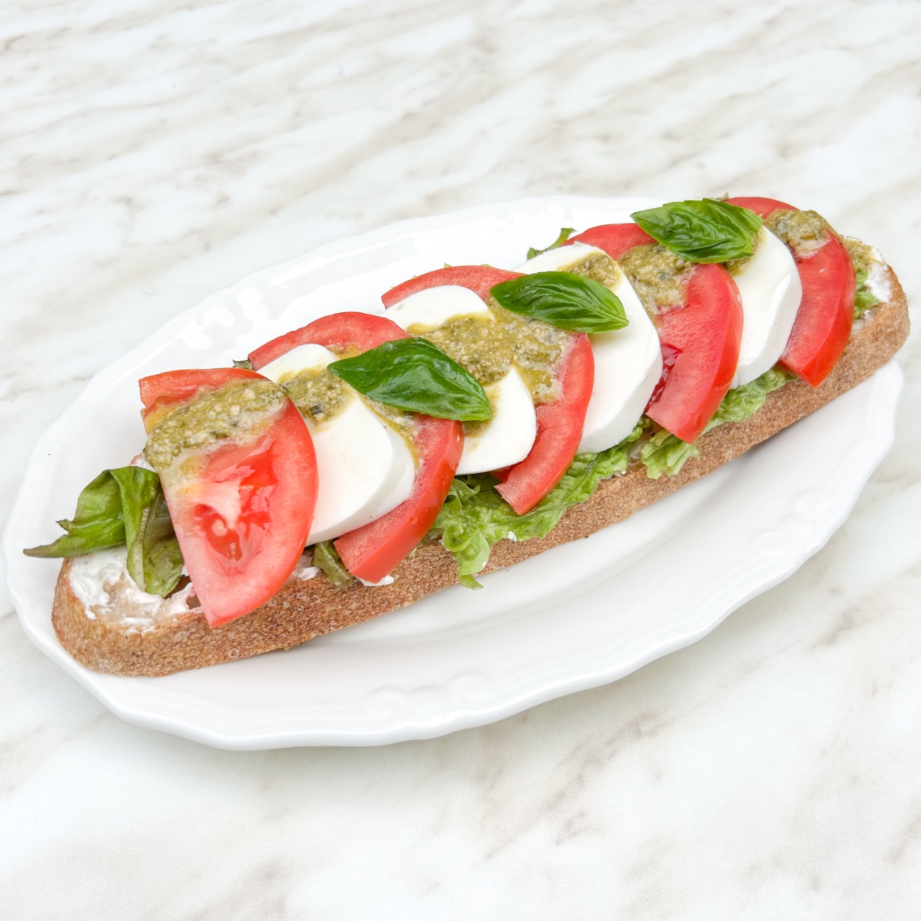 Mozarella Caprese Ekmeküstü - Ekşi Mayalı Ekmek, Pesto Sos, Peynir Sos, Mozarella, Domates, Fesleğen, Kıvırcık.