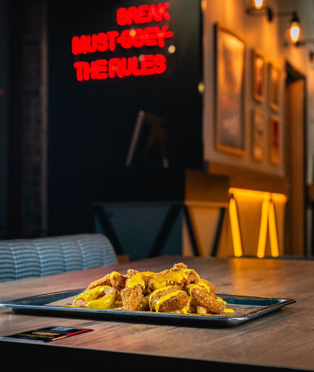 Golden Snacks Mix - 4 tenders, 4 onion rings, served on tater tots with cheddar sauce.