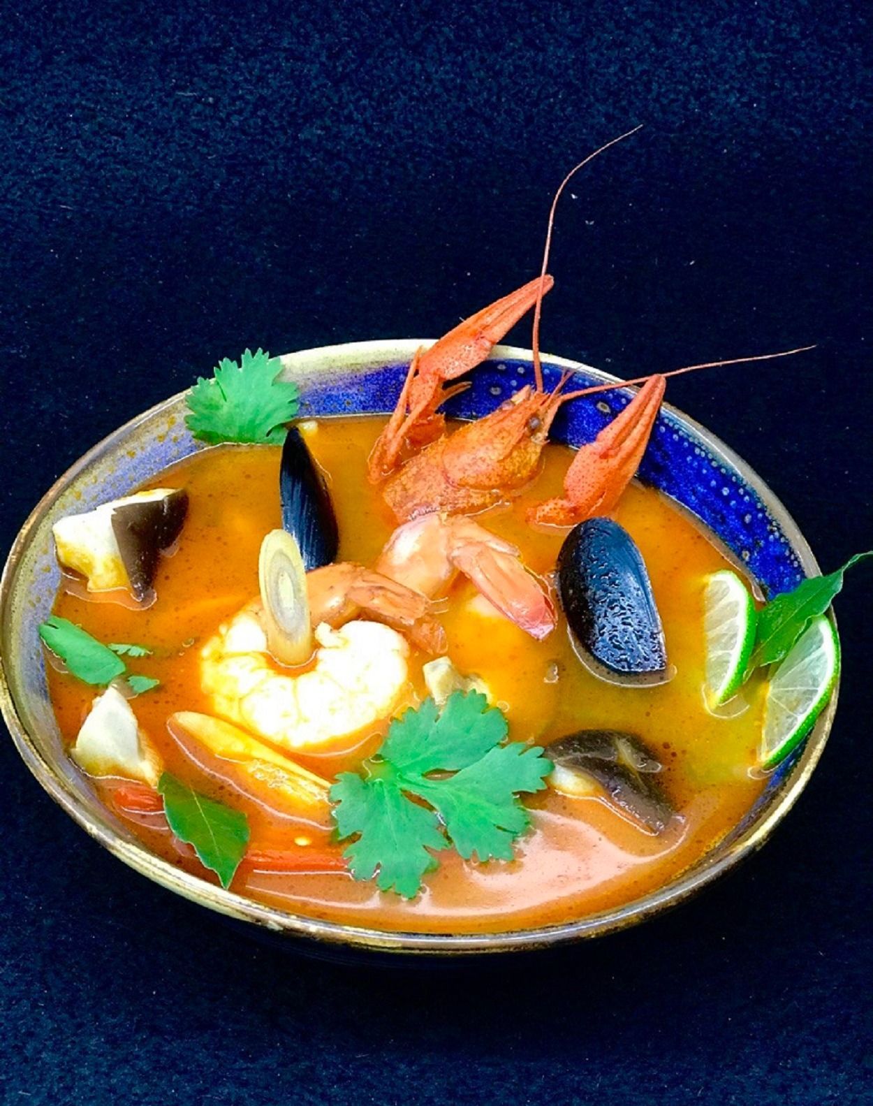Tom Yam - Tom Yam Soup with spicy Thai broth, mussels, calamari, shrimp, and lobster