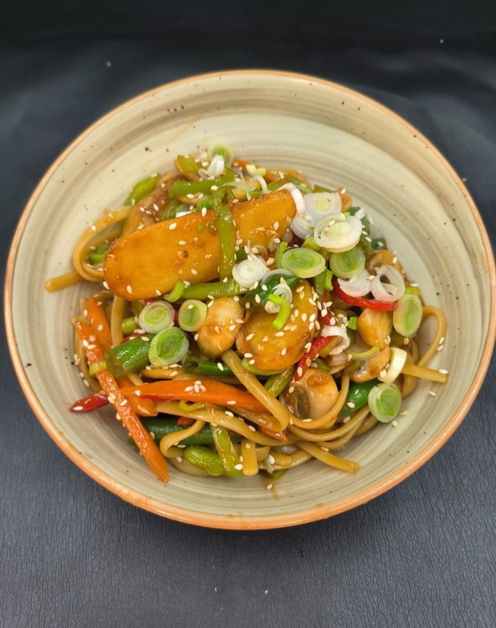 Vegetarian Udon Thai - Vegetarian Udon Thai with udon noodles, bell peppers, carrots, broccoli, mushrooms, green onions, and spicy Thai-style sauce