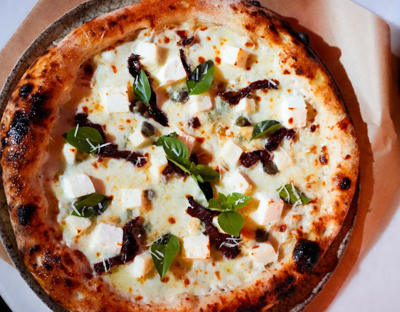 Quattro Formaggi - 24 hours fermented sourdough ,special formaggi sauce , fresh mozzarella cheese ,white cheese ,halloumi cheese ,Roquefort cheese ,parmesan cheese ,dried tomsto ,capers , fresh basil , olive oil