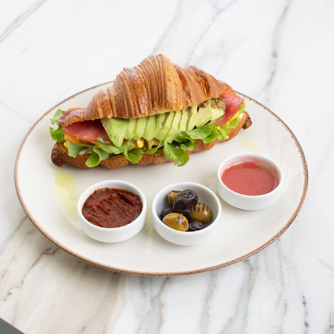 Roastbeef Kruvasan - Kruavasan, peynir sos, çırpılmış yumurta, tütsülenmiş et, avocado ve pesto sos