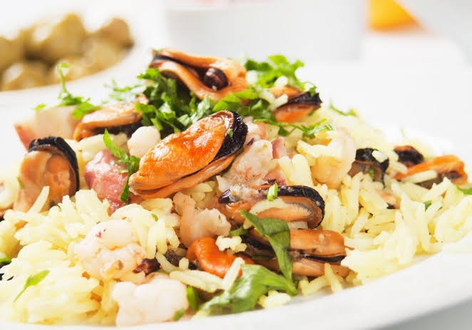 Risotto di Mare - Risotto Rice, Calamari, Jumbo Shrimp in Butter, Mussels, Roasted Garlic Cloves, Parsley